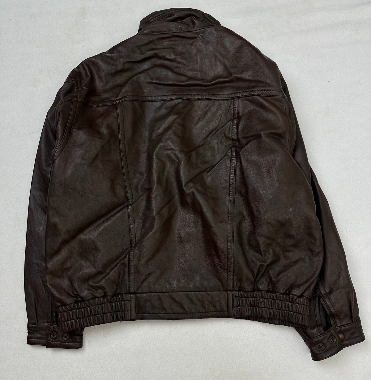 Back of the size L burgundy leather flight jacket, laid flat