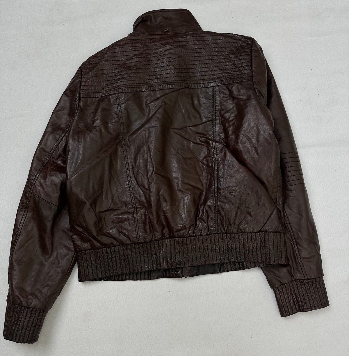 Back of the size S burgundy leather flight jacket, laid flat
