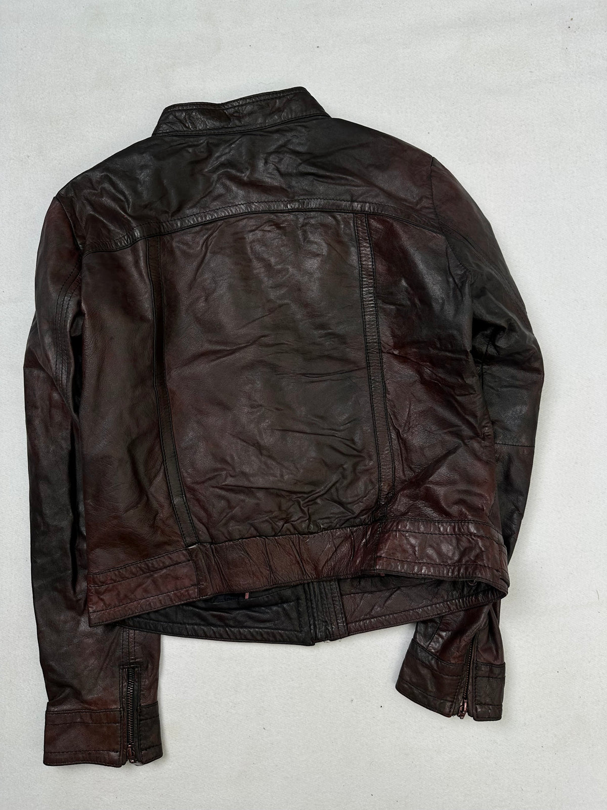 Back of the size S burgundy leather cafe racer jacket, laid flat