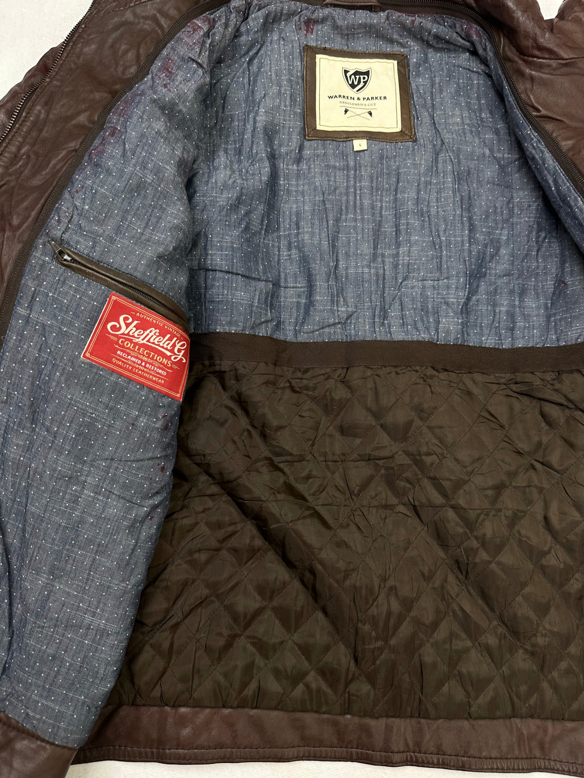The size L burgundy leather cafe racer jacket opened to show the lining