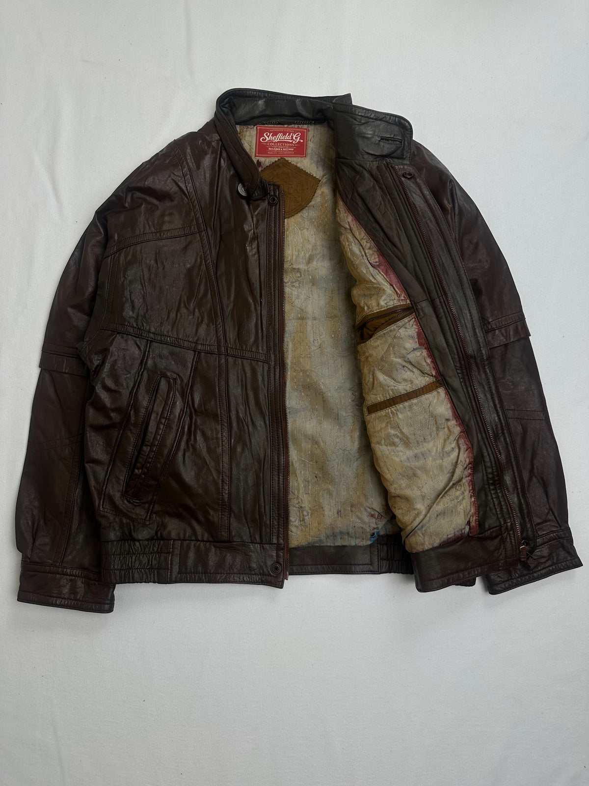 Cream fleece lining and the interior zip pocket on the brown vintage jacket