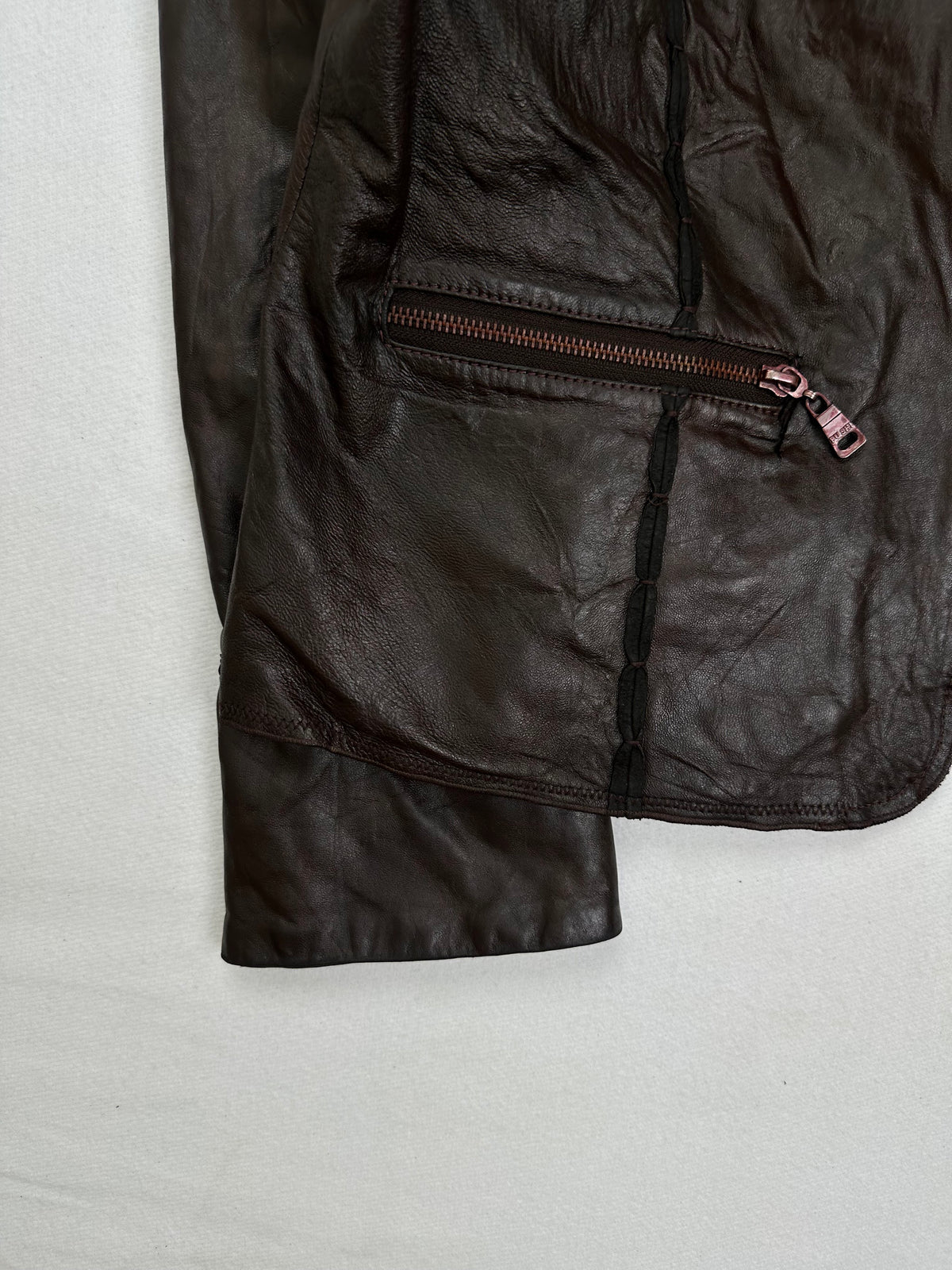 Close detail of the pockets and cuff on the size S brown leather cafe racer jacket