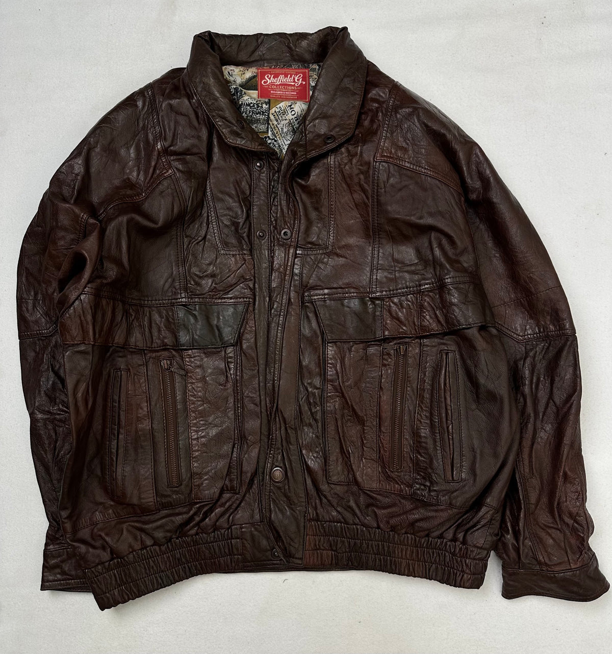 Front of the size XL burgundy leather flight jacket, laid flat and unedited