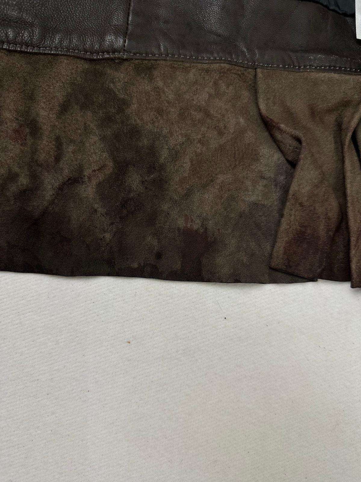 A small mark on the size XS burgundy leather biker jacket, shown up close