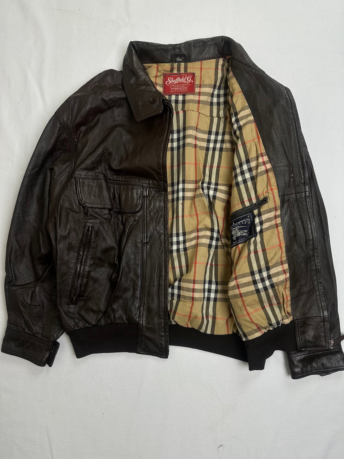 Tan check lining in black, white and red shown with the jacket open
