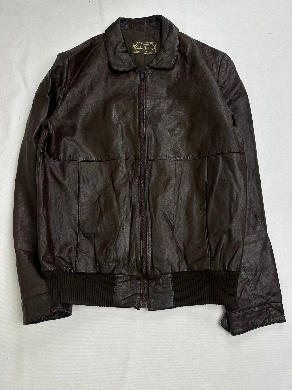 Back of the size L brown flight jacket laid flat