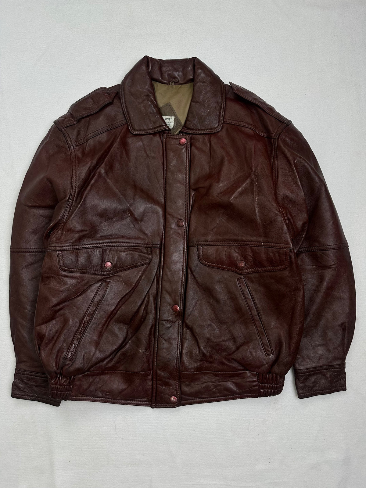 Front of the size L burgundy leather flight jacket, laid flat and unedited
