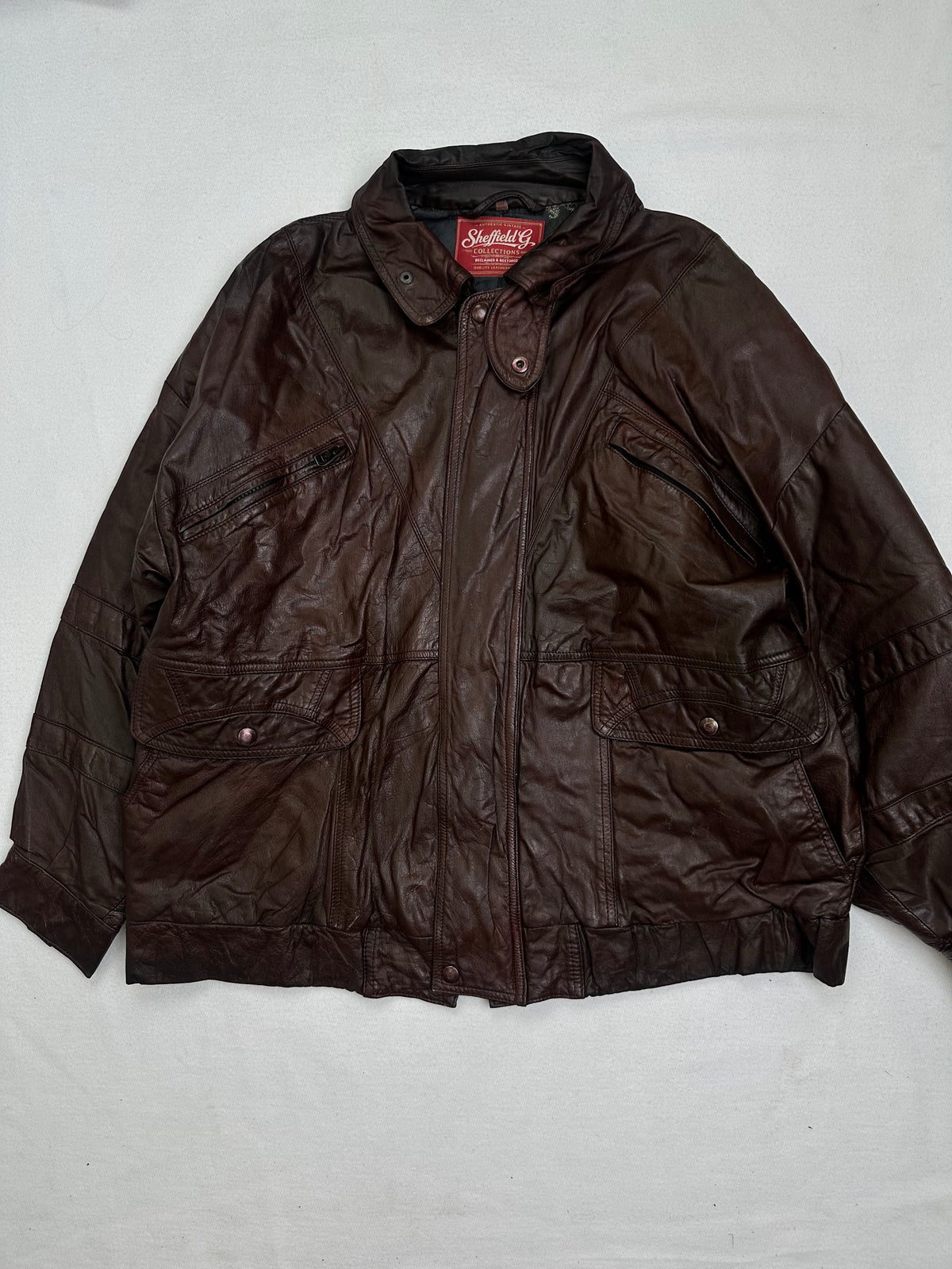 Front of the size M burgundy leather flight jacket, laid flat and unedited