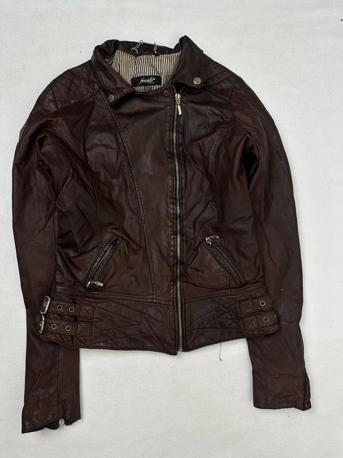 Front of the size S burgundy leather biker jacket, laid flat and unedited