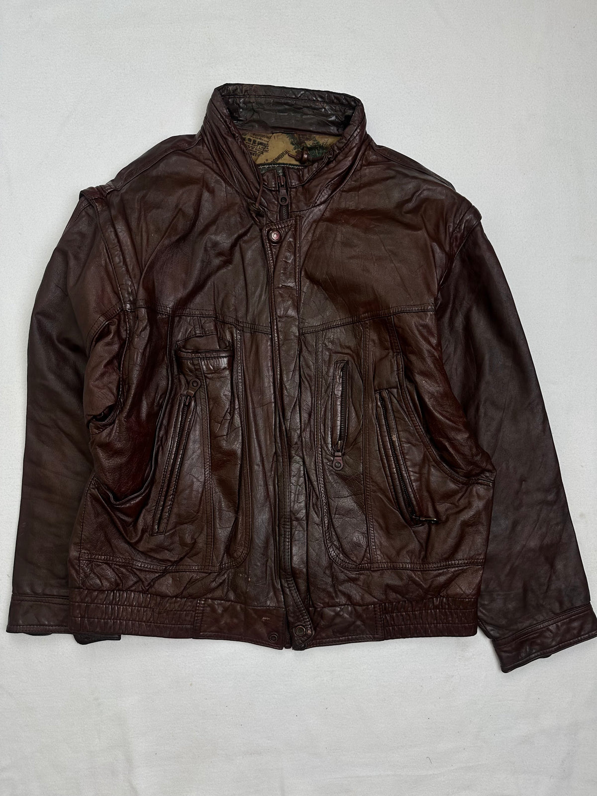 Front of the size L burgundy leather flight jacket, laid flat and unedited