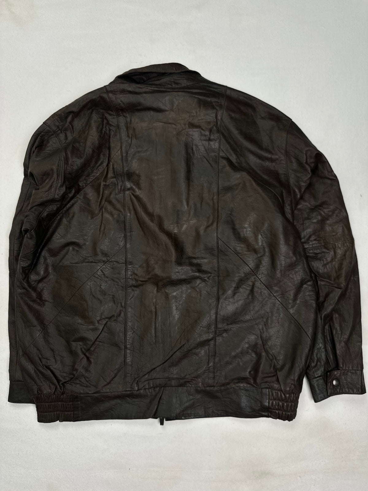 Pointed collar on a short stand above the covered placket