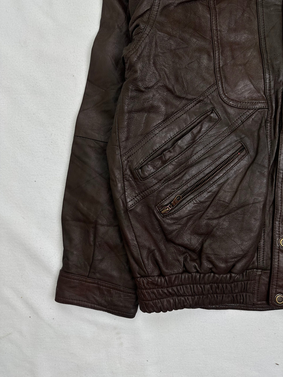 Close detail of the pockets and cuff on the size M burgundy leather vintage jacket