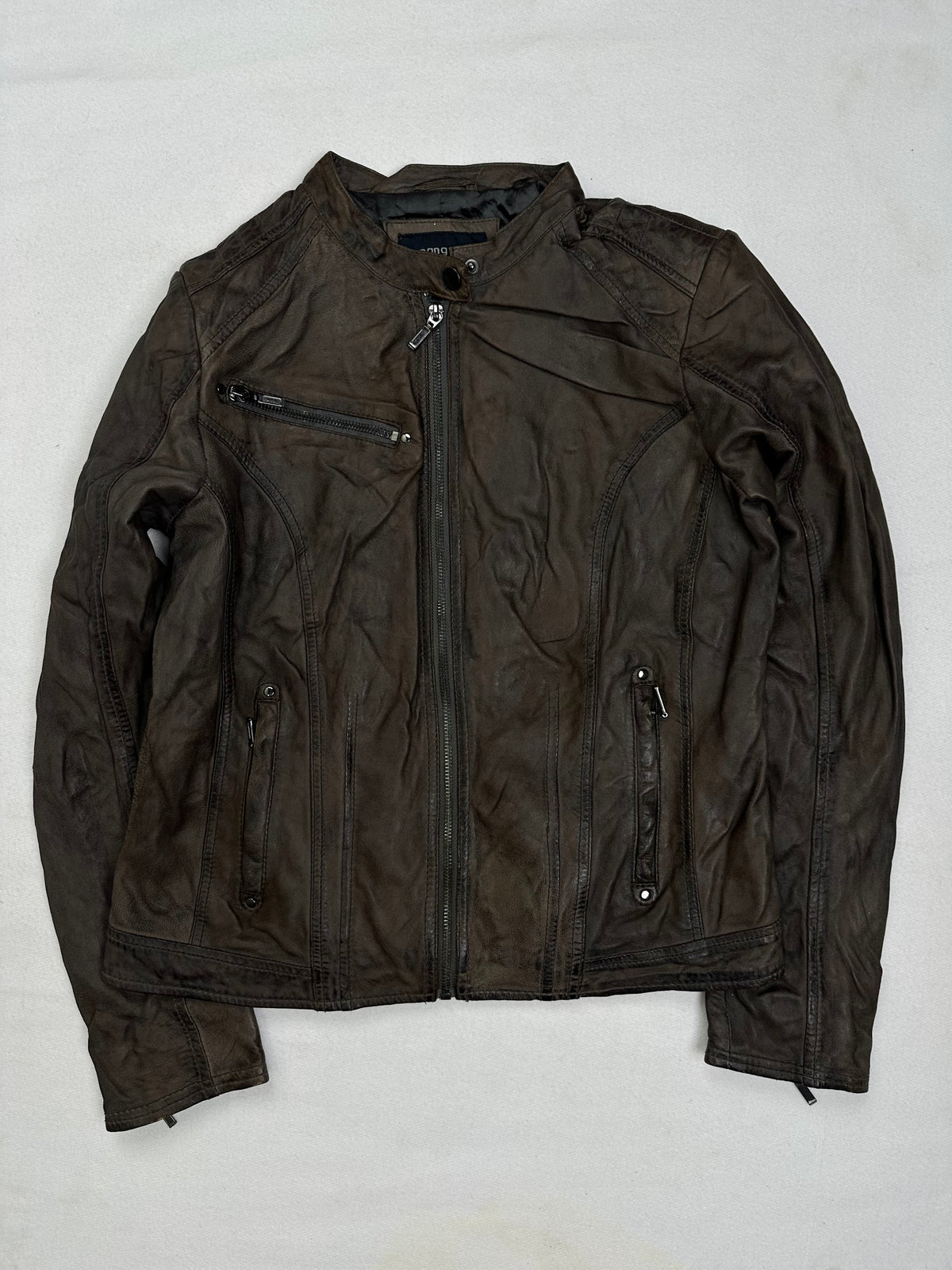 Front of the size S brown leather cafe racer jacket, laid flat and unedited