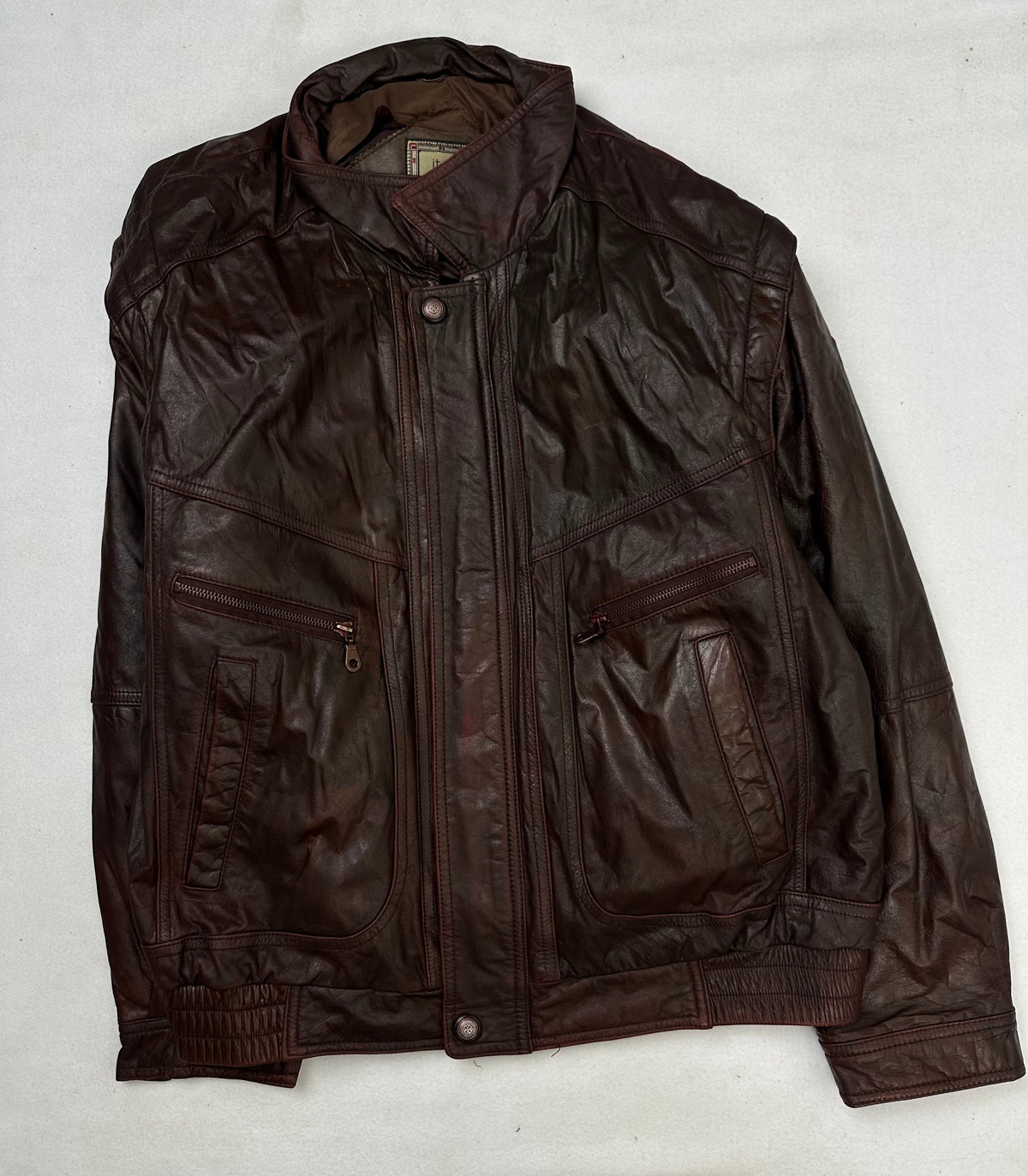 Front of the size L burgundy leather flight jacket, laid flat and unedited