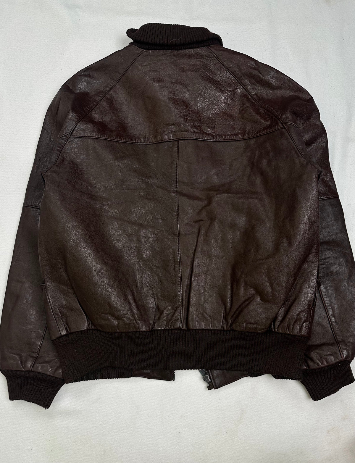 Ribbed knit band collar above the straight centre zip