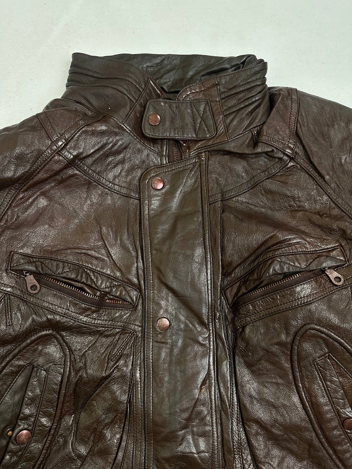 Shoulder seams and collar fold showing light surface rubbing