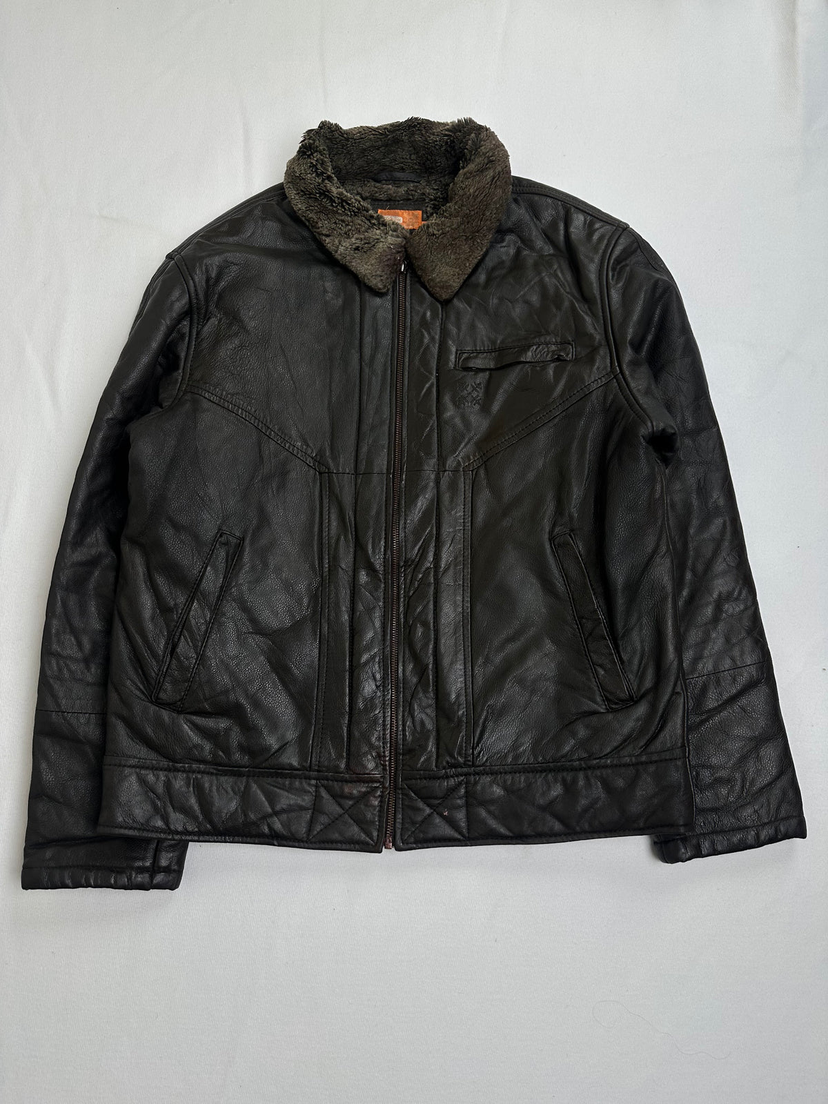 Welt pocket and the flat leather waist band on the brown flight jacket