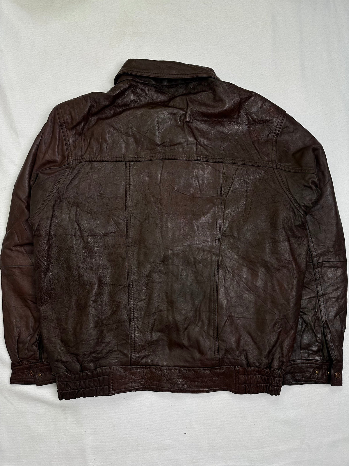 Back of the size M burgundy leather vintage jacket, laid flat