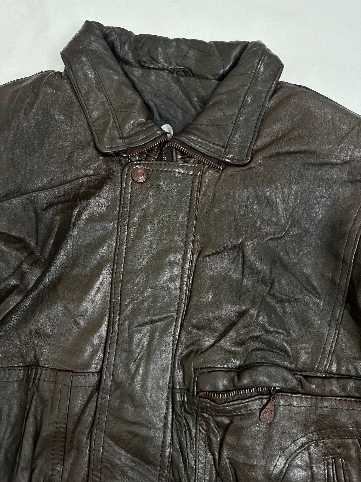 Antique copper snaps fastening the storm placket over the centre zip
