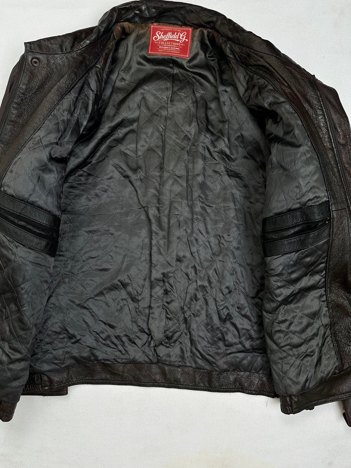 The size L brown leather flight jacket opened to show the lining