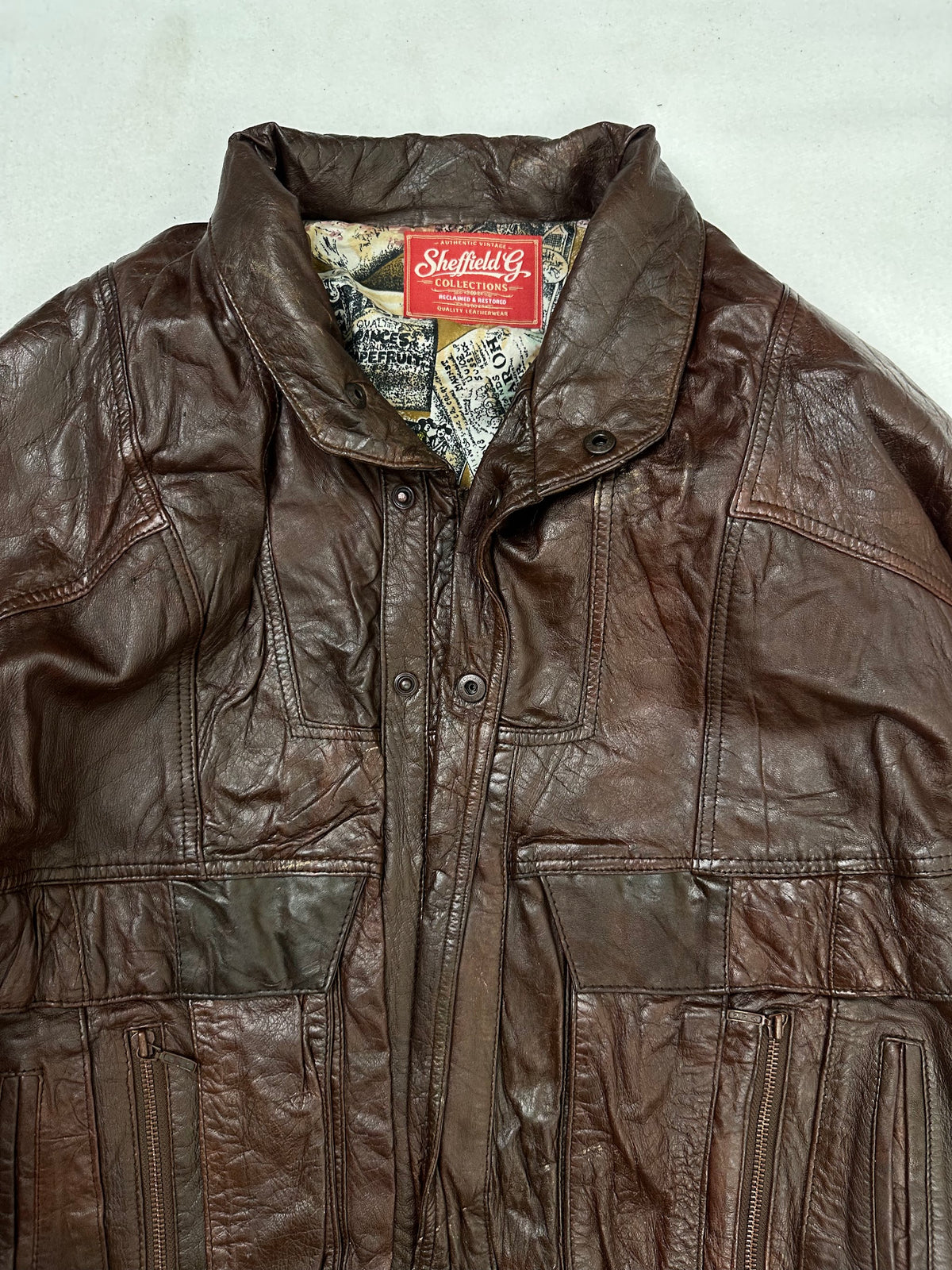 Collar and zip of the size XL burgundy leather flight jacket, up close