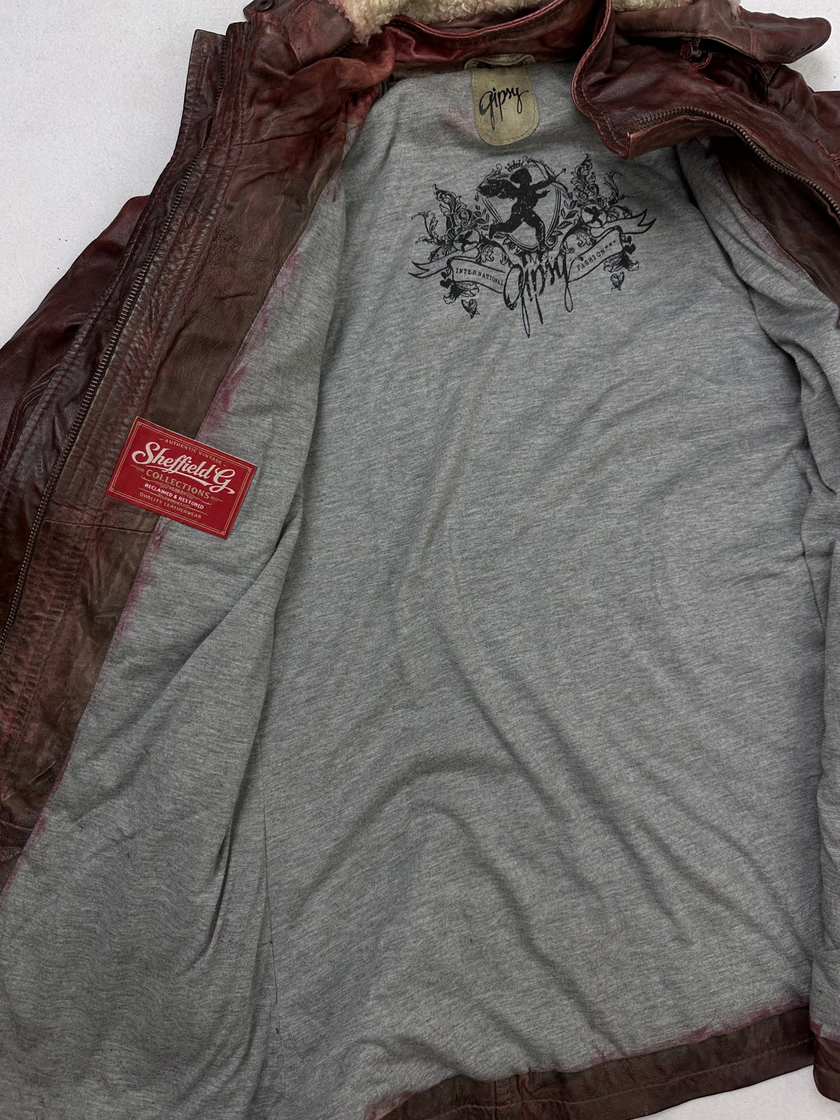 The size L burgundy leather hooded jacket opened to show the lining