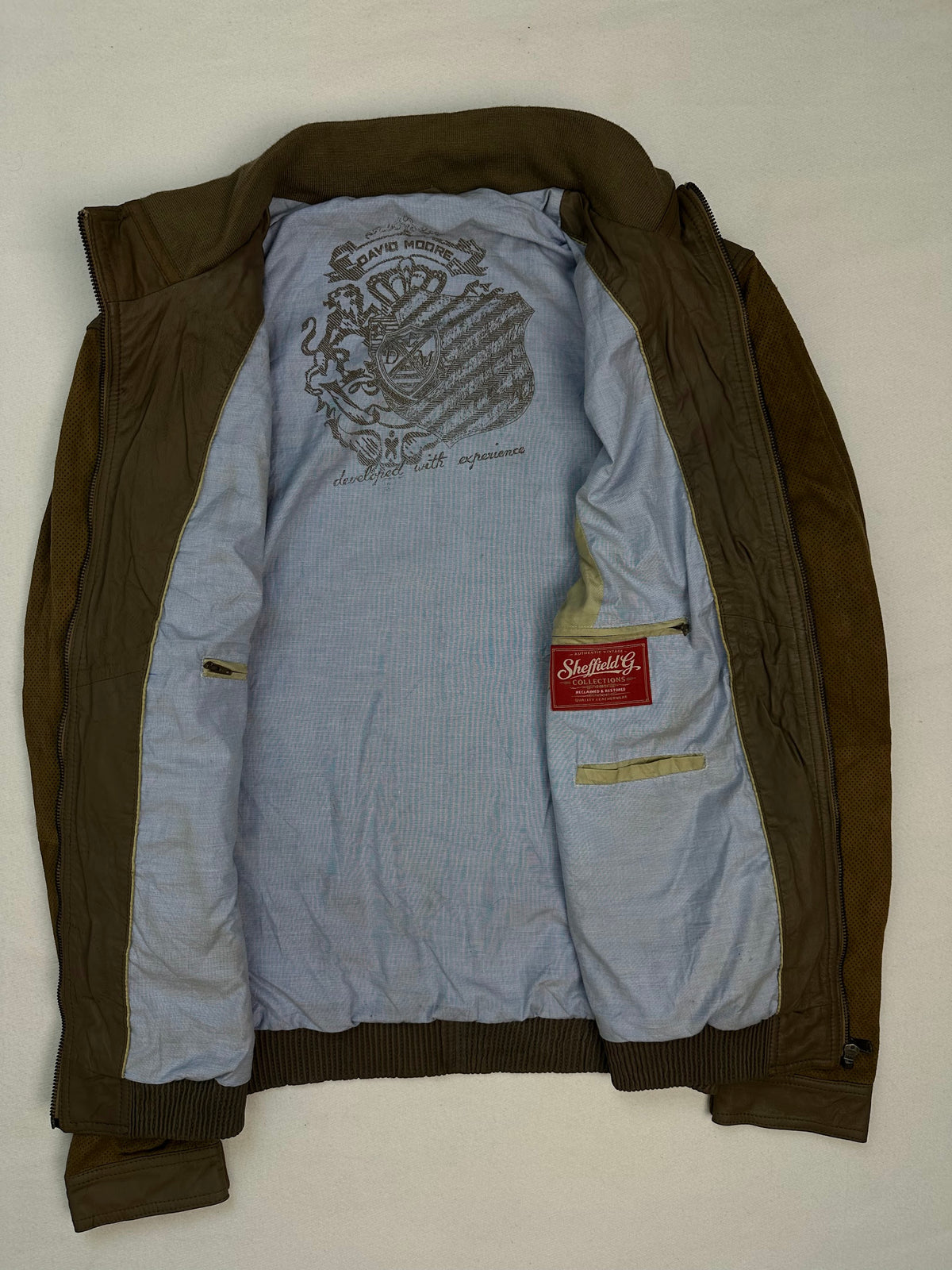 The size L brown leather cafe racer jacket opened to show the lining