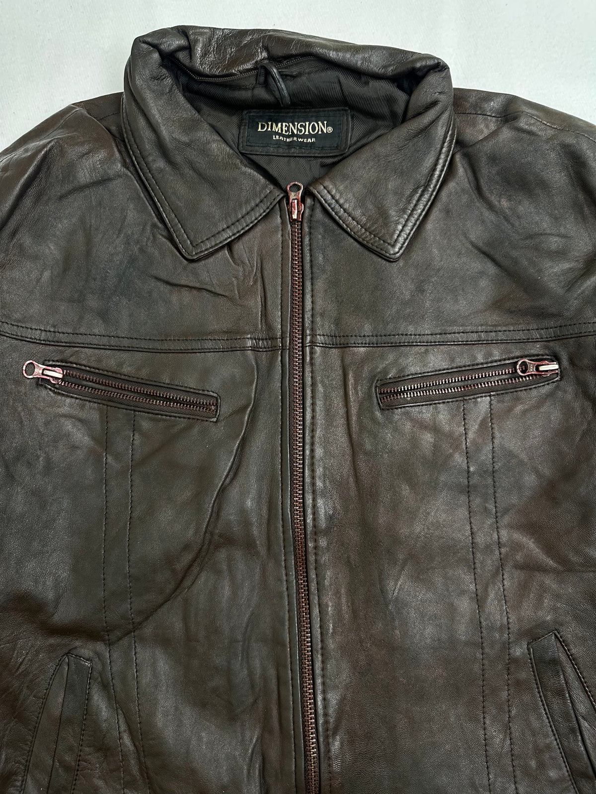 Interior zip pockets shown in the open lining of the trucker