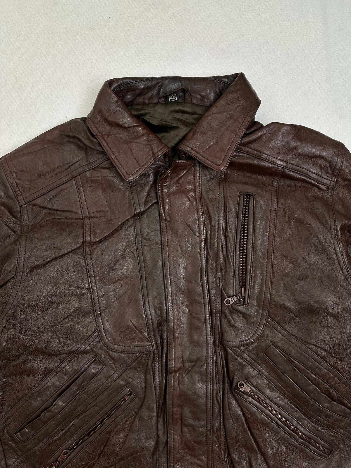 Inside of the collar on the size M burgundy leather vintage jacket