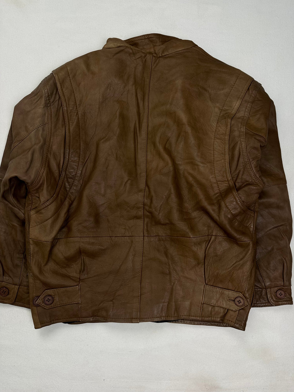 Mandarin band collar above the button through front placket