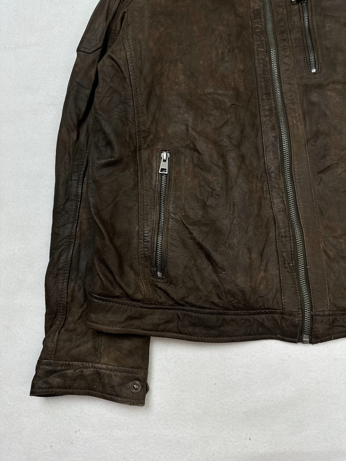 Close detail of the pockets and cuff on the size M brown leather cafe racer jacket