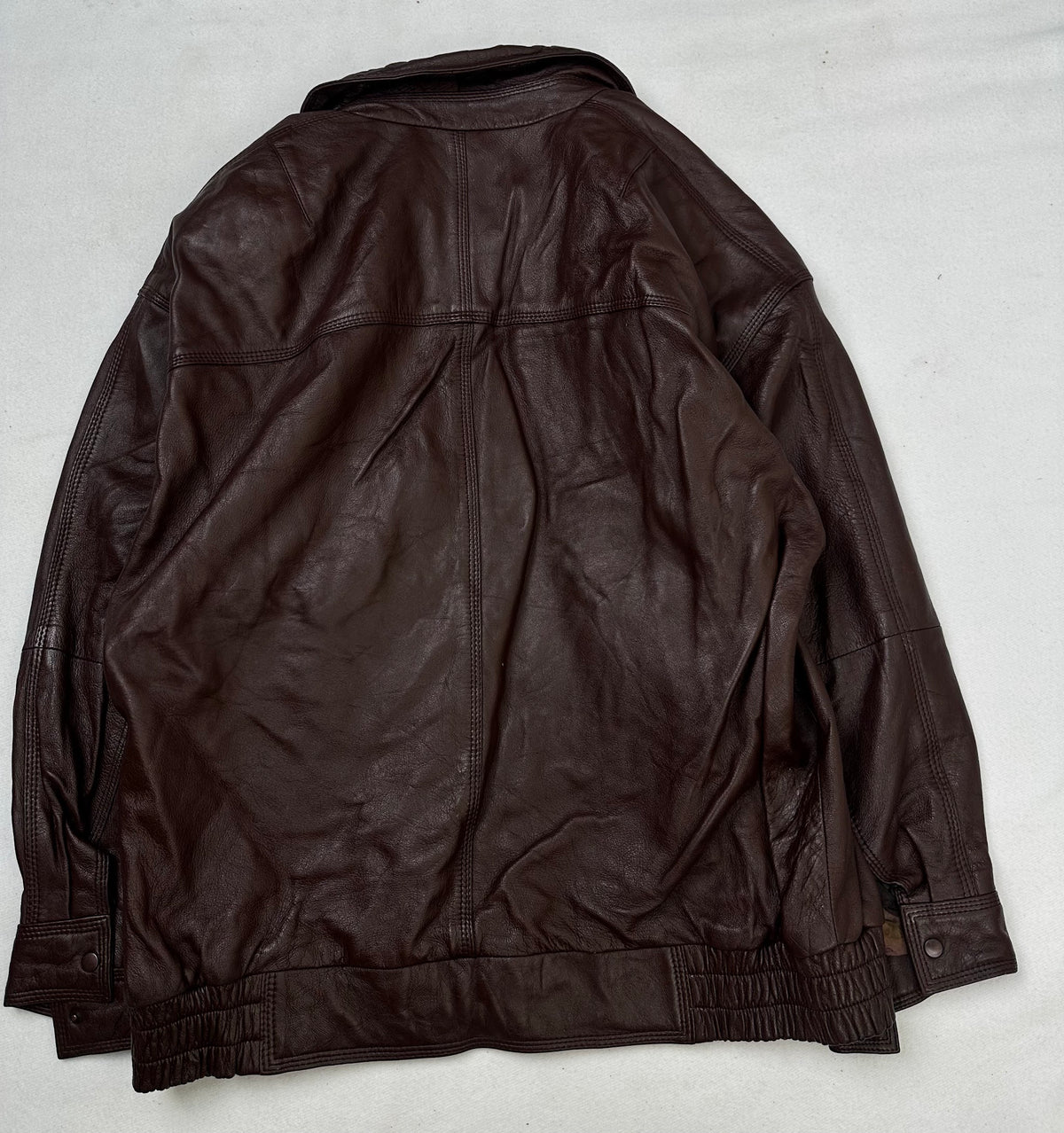 Back of the size L burgundy leather harrington jacket, laid flat