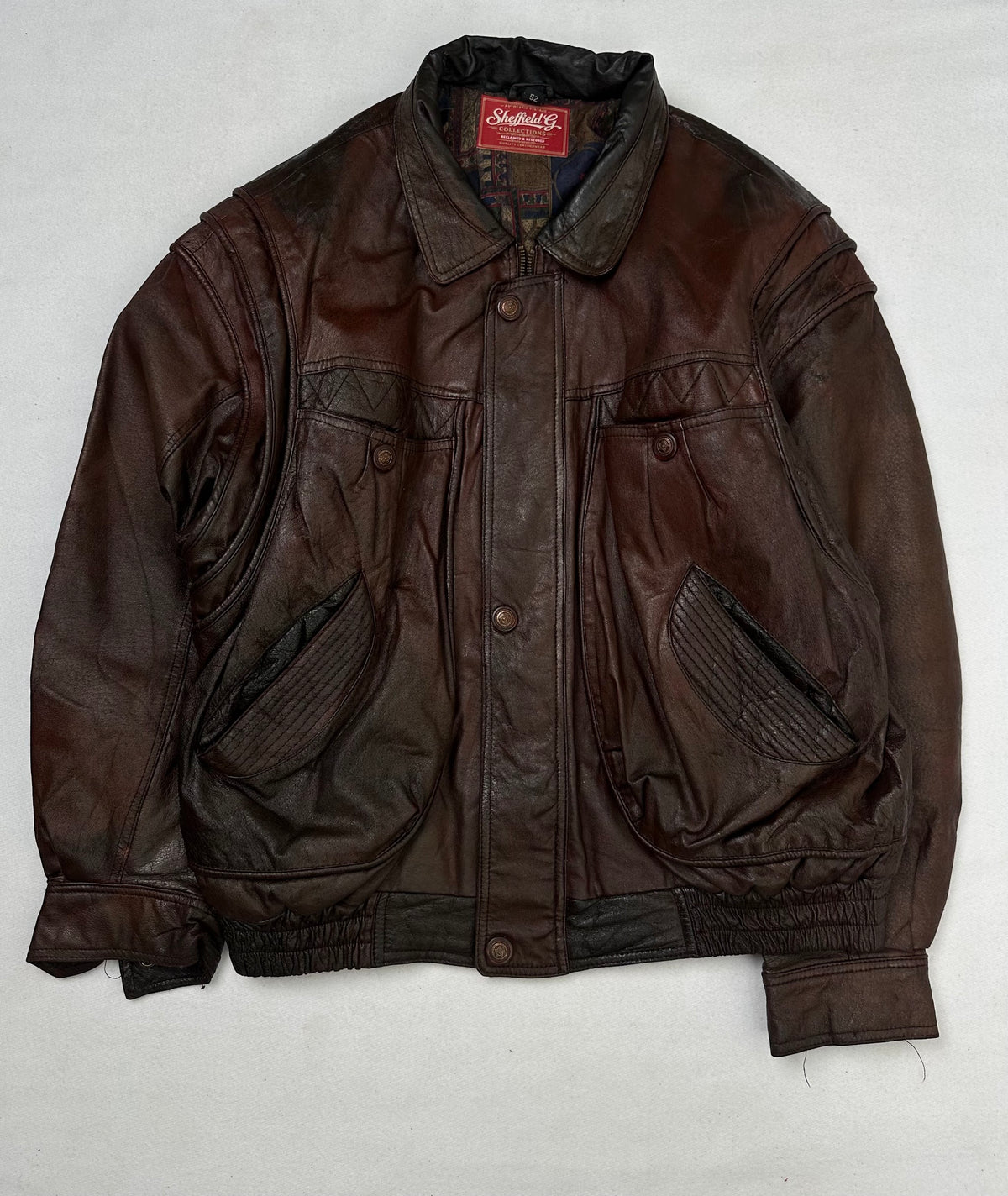 Front of the size L burgundy leather flight jacket, laid flat and unedited