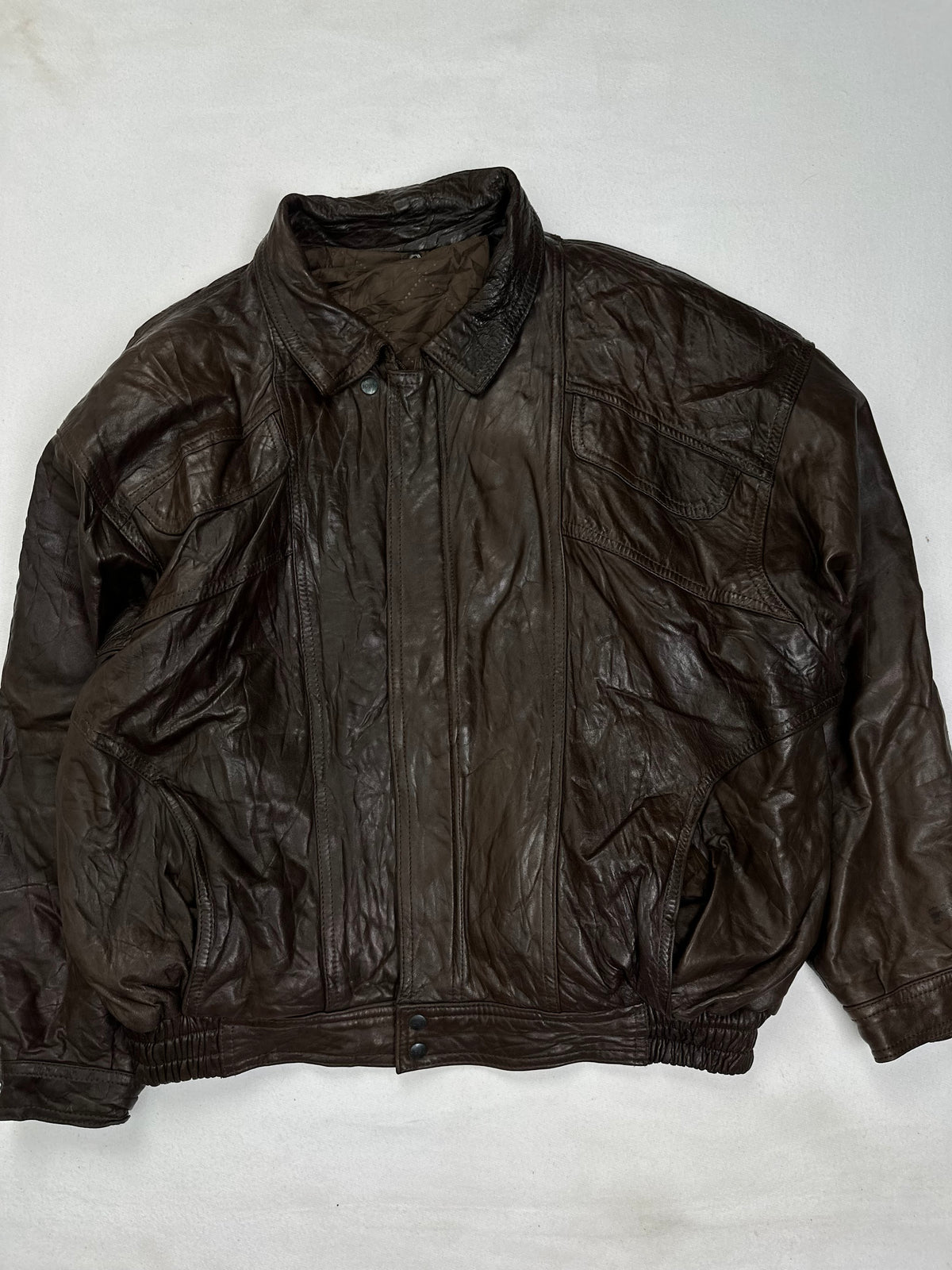 Back of the size L brown harrington jacket laid flat