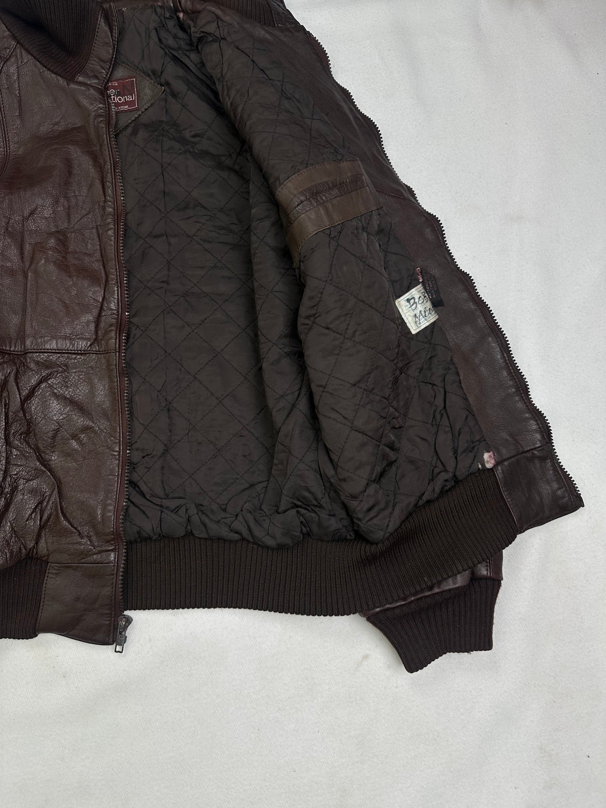 Dark diamond quilted lining shown with the bomber held open