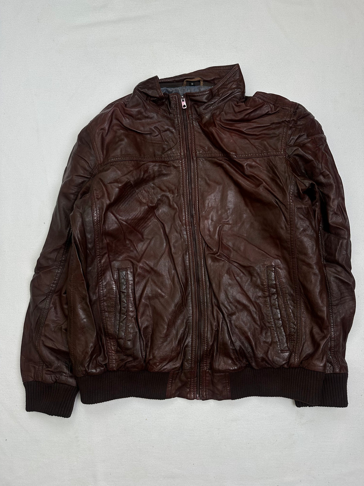 Front of the size XL burgundy leather bomber jacket, laid flat and unedited