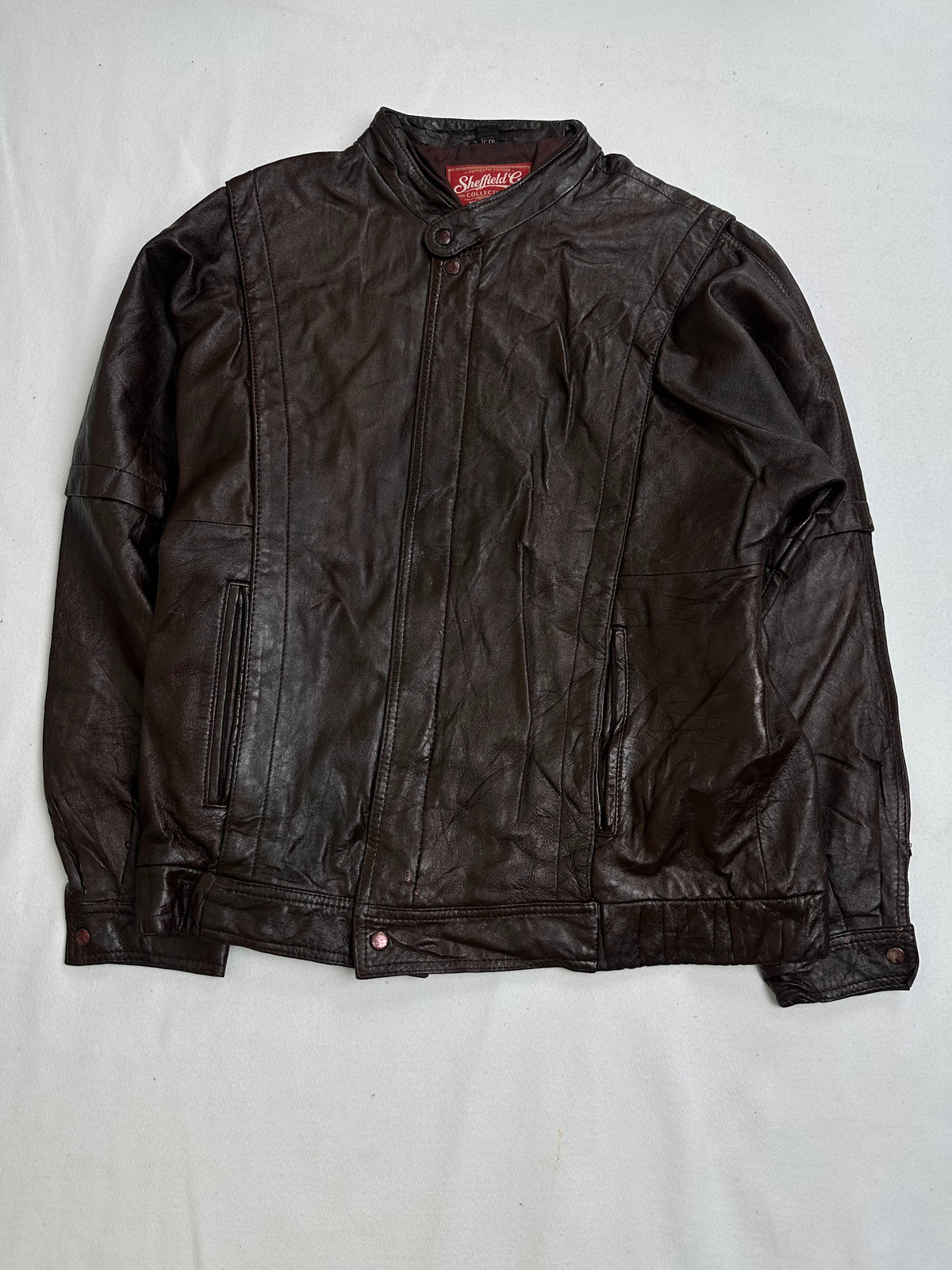 Back of the size L brown cafe racer jacket laid flat