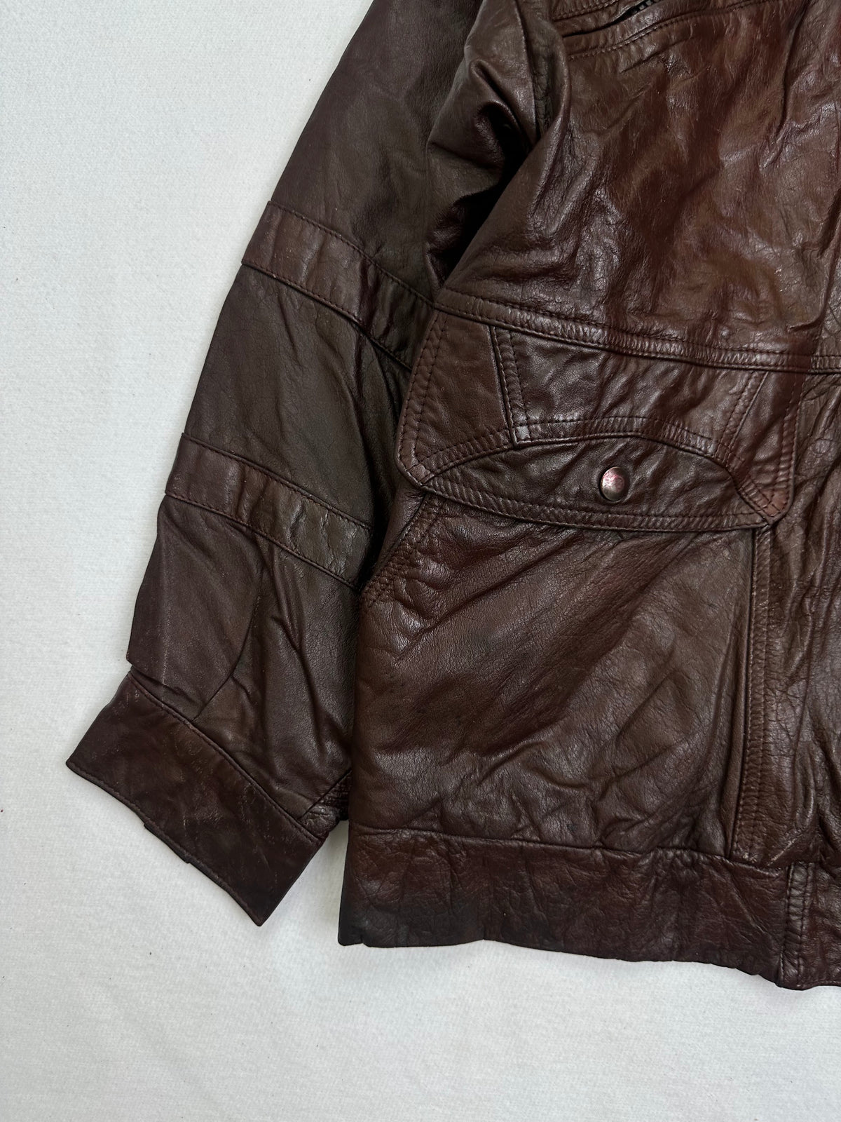 Close detail of the pockets and cuff on the size M burgundy leather flight jacket