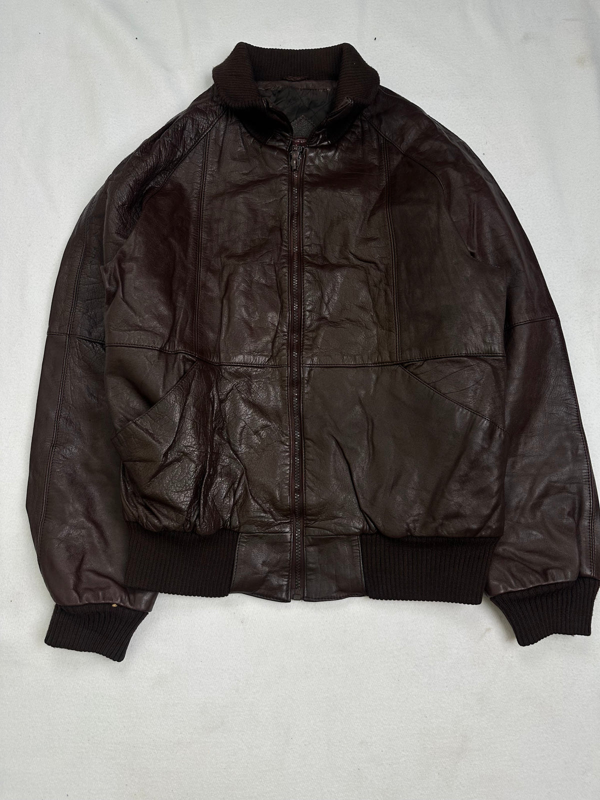 Back of the size L brown bomber jacket laid flat