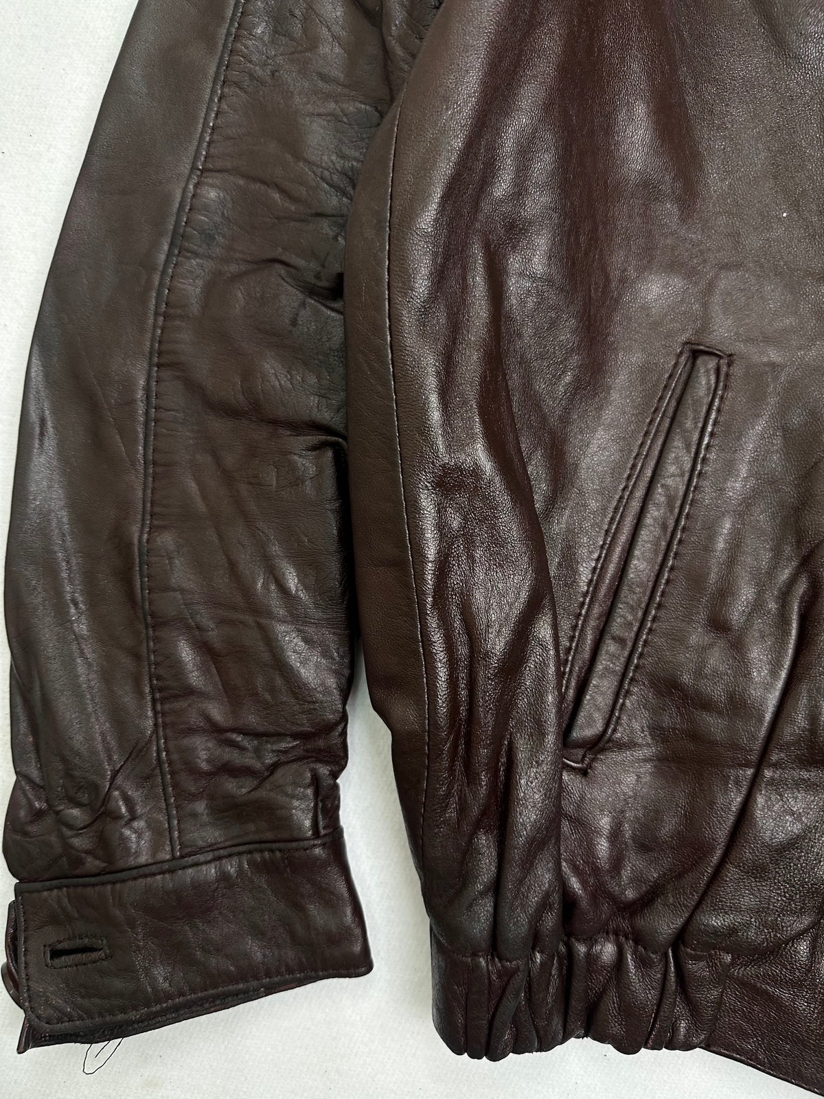 Close detail of the pockets and cuff on the size M burgundy leather harrington jacket