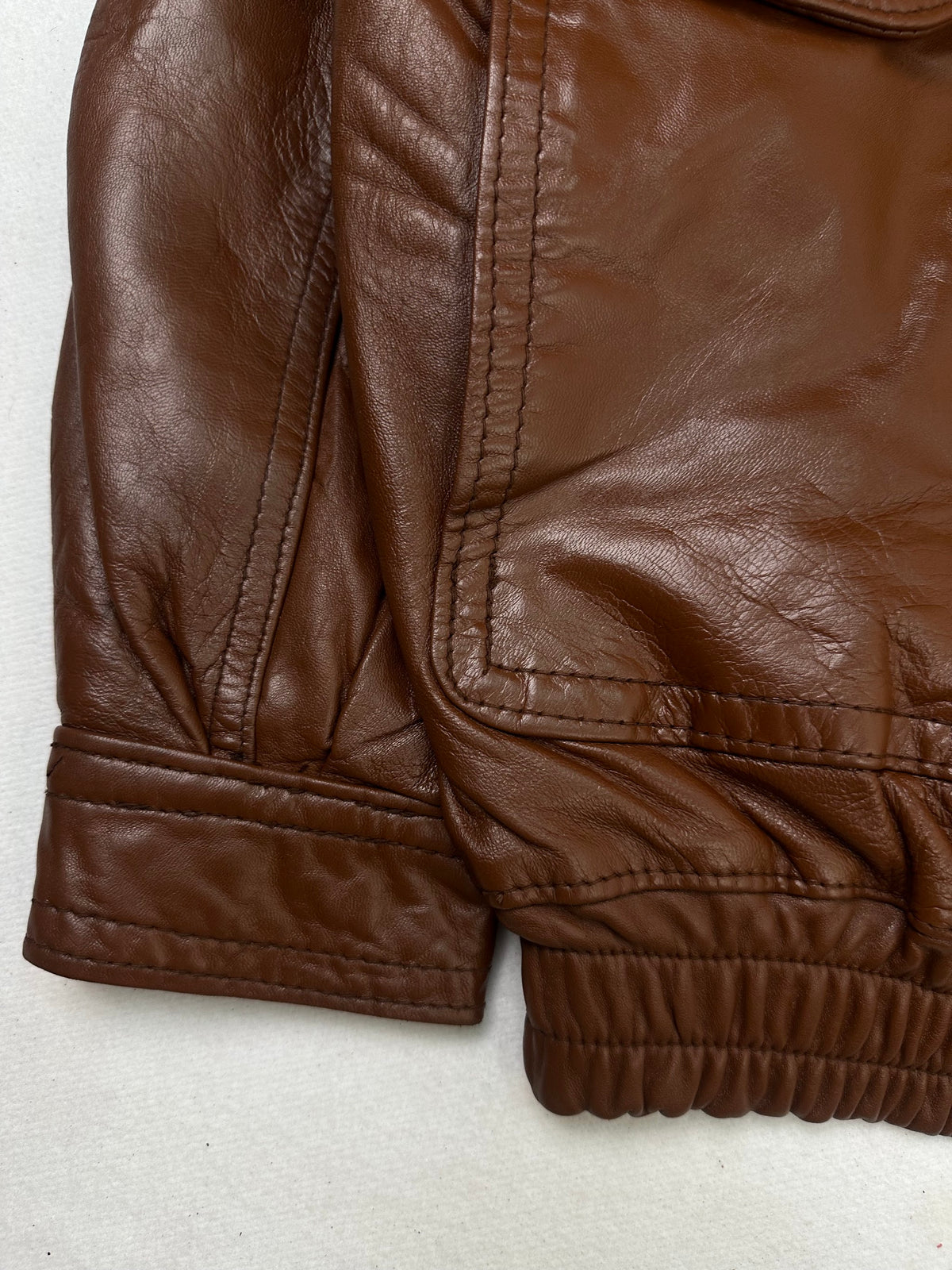 Close detail of the pockets and cuff on the size L brown leather flight jacket