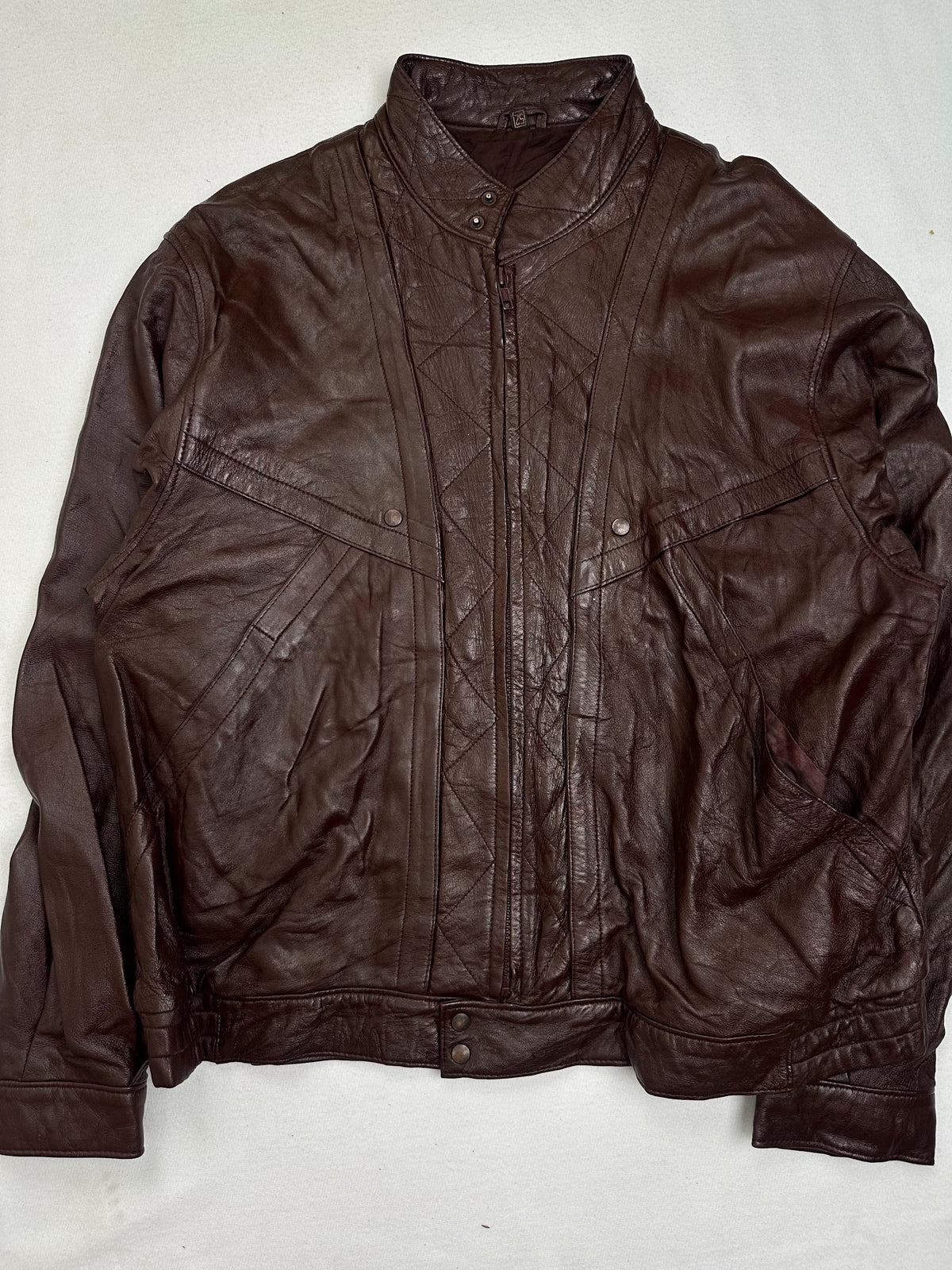 Front of the size L burgundy leather vintage jacket, laid flat and unedited