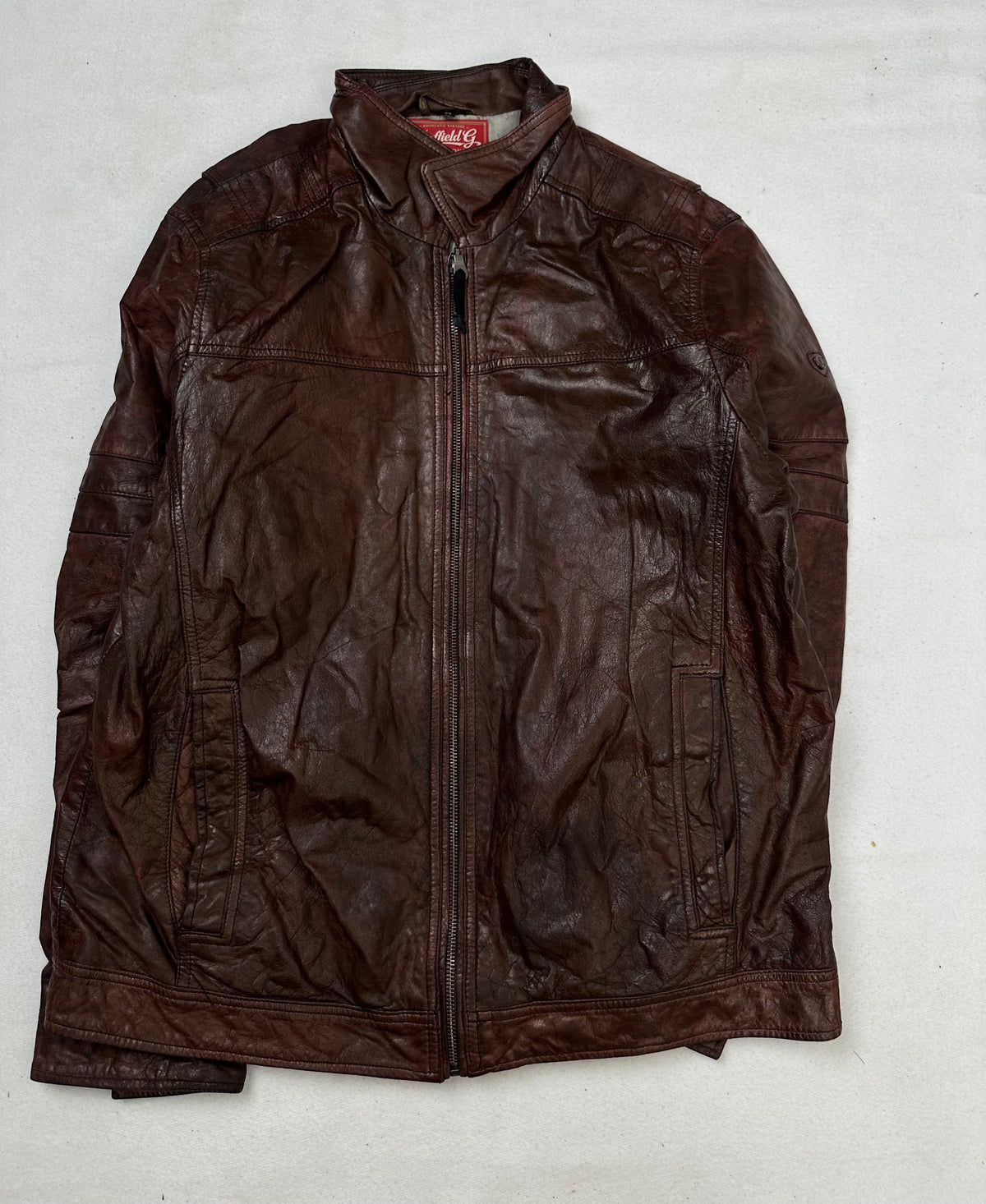 Front of the size L burgundy leather vintage jacket, laid flat and unedited