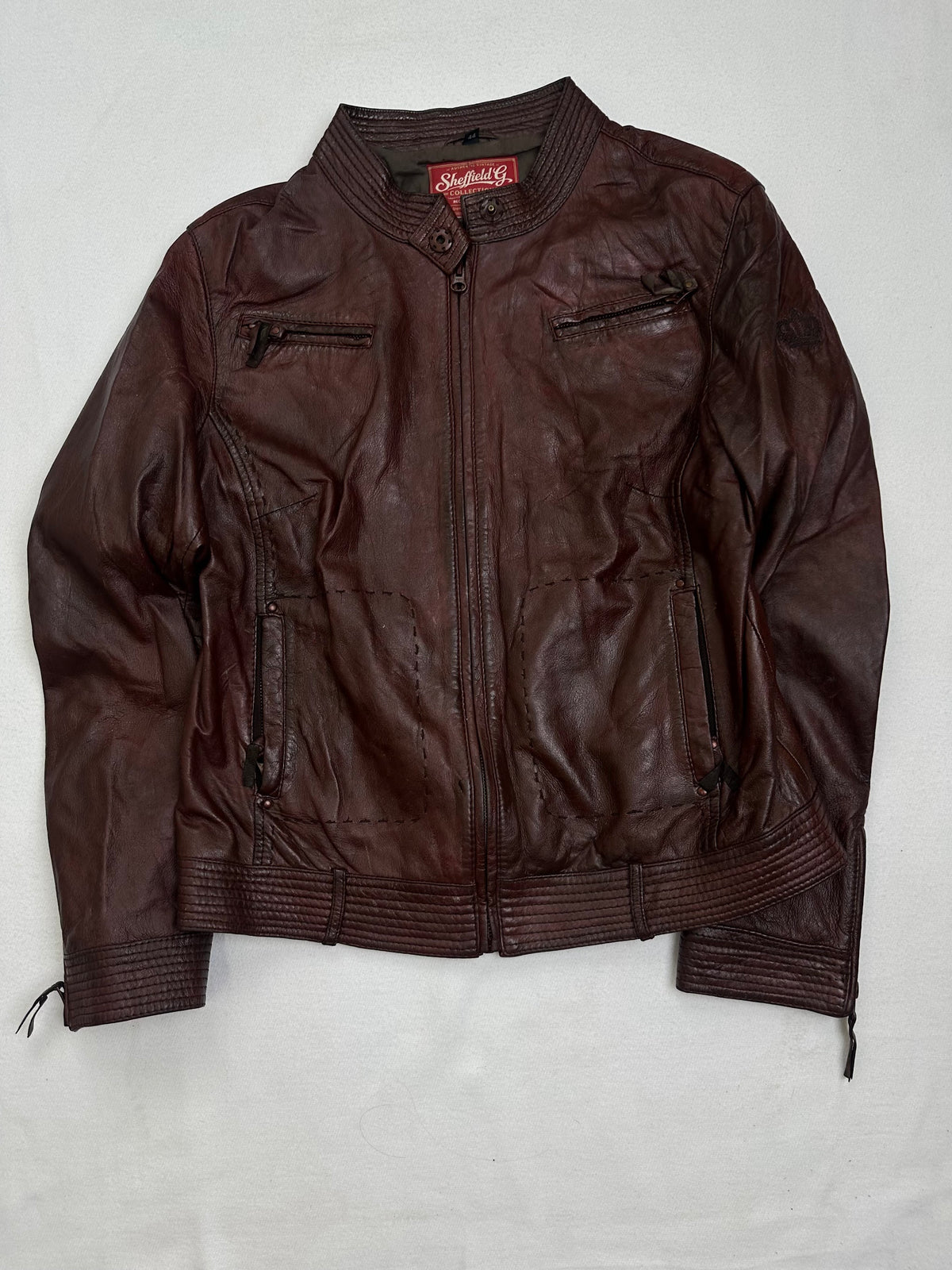 Front of the size S burgundy leather cafe racer jacket, laid flat and unedited