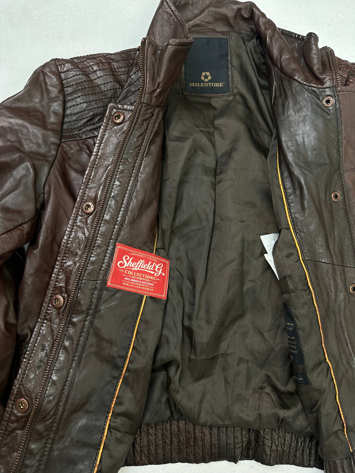 The size S burgundy leather flight jacket opened to show the lining