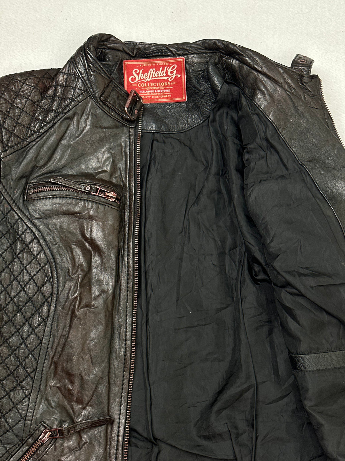 Inside of the collar on the size S brown leather cafe racer jacket