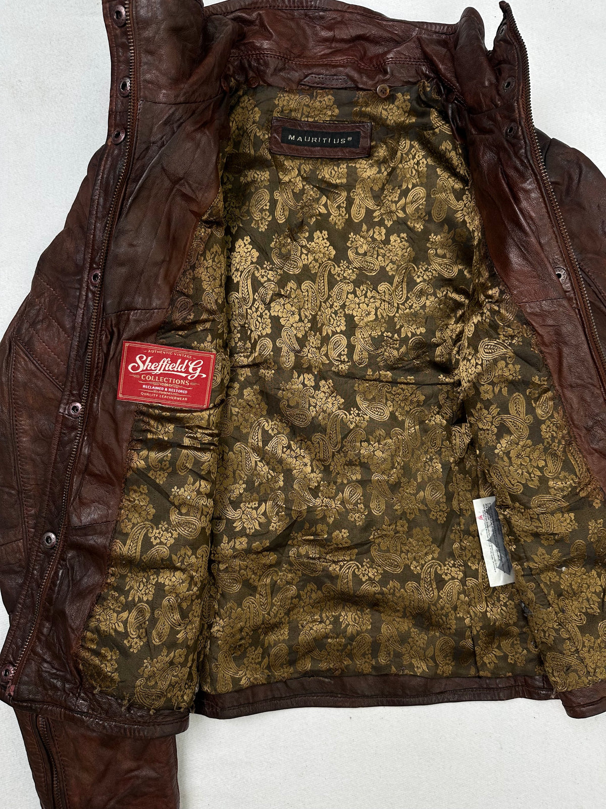 The size S burgundy leather cafe racer jacket opened to show the lining