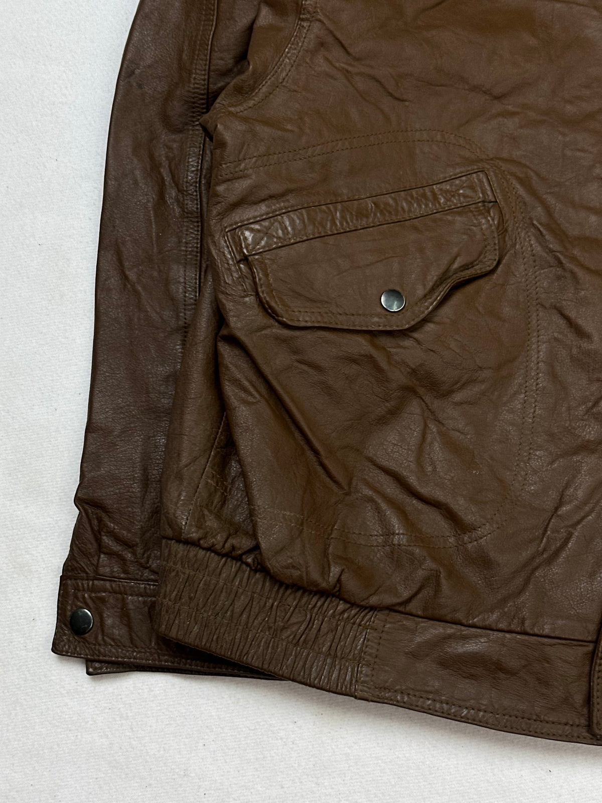 Close detail of the pockets and cuff on the size M brown leather flight jacket