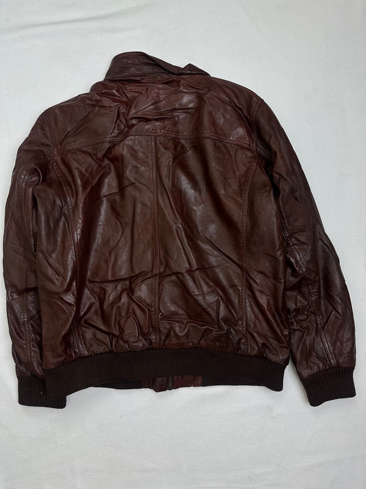 Back of the size XL burgundy leather bomber jacket, laid flat