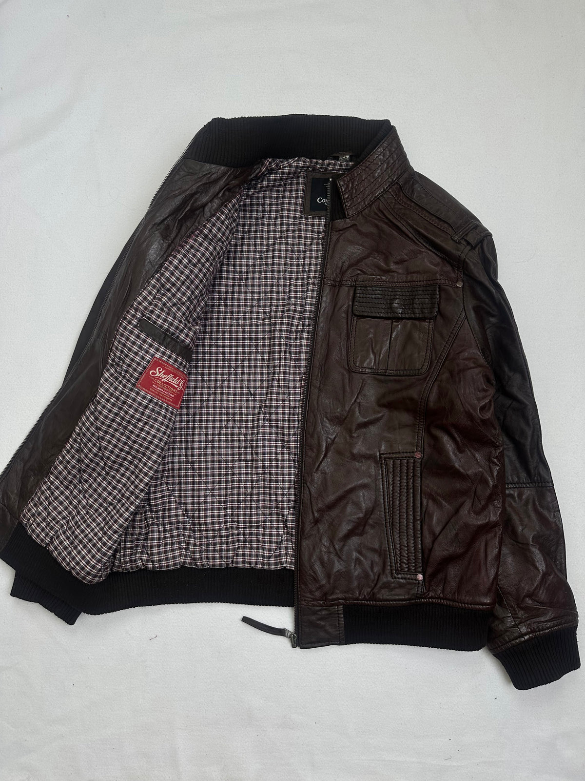 The size L burgundy leather bomber jacket opened to show the lining